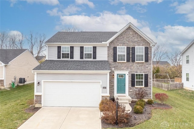 view of front of house featuring cooling unit, a garage, and a front yard