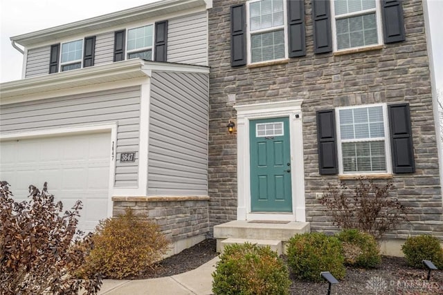 doorway to property featuring a garage