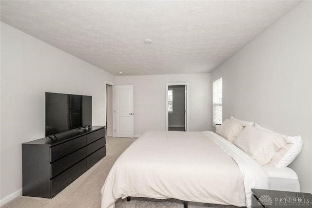 carpeted bedroom featuring a textured ceiling