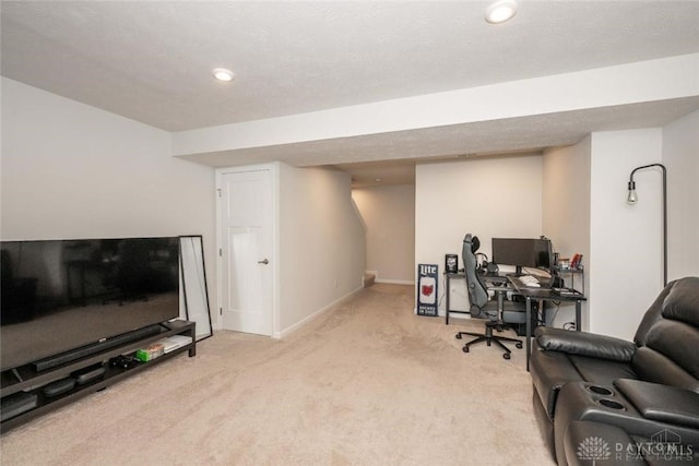 carpeted office space with a textured ceiling