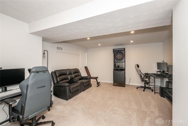 office space featuring light colored carpet and a textured ceiling