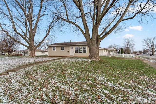 rear view of house featuring a lawn