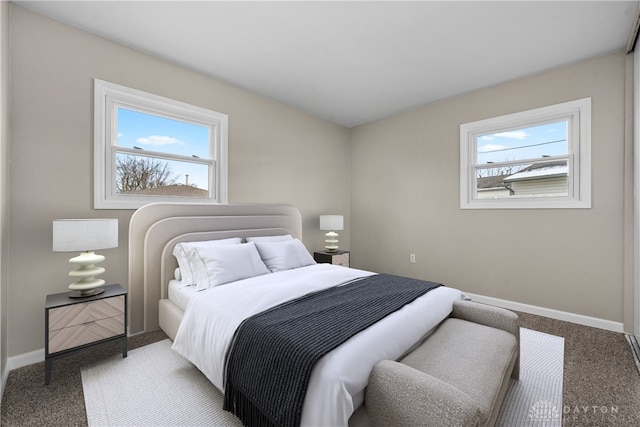 carpeted bedroom featuring multiple windows