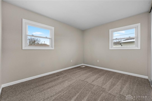 carpeted spare room with plenty of natural light