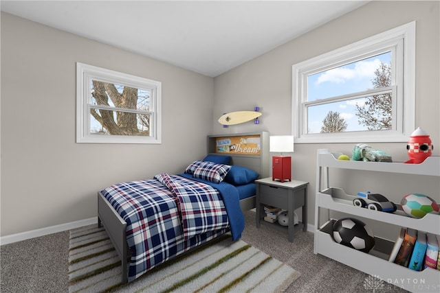 carpeted bedroom featuring multiple windows