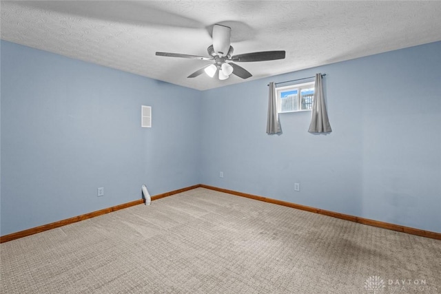 unfurnished room featuring carpet, ceiling fan, and a textured ceiling