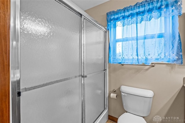 bathroom featuring toilet and walk in shower