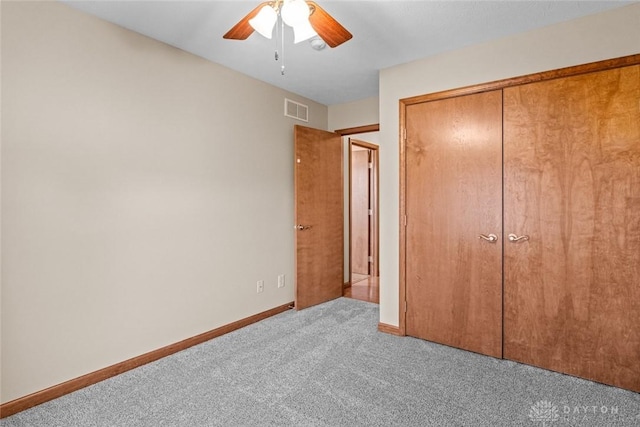 unfurnished bedroom featuring carpet flooring, a closet, and ceiling fan