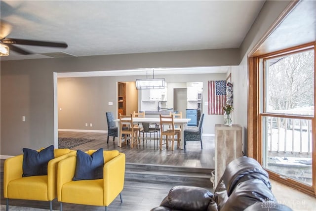 living room featuring dark hardwood / wood-style floors and ceiling fan