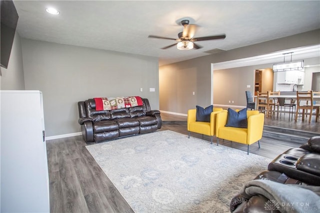 living room with ceiling fan and hardwood / wood-style floors