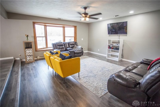 living room with dark hardwood / wood-style flooring, a baseboard radiator, and ceiling fan