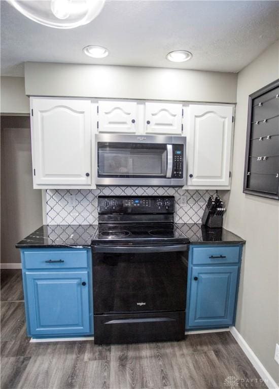 kitchen with white cabinets, dark wood-type flooring, and black electric range