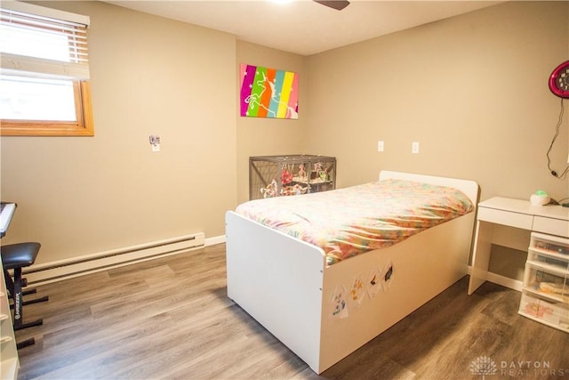 bedroom with hardwood / wood-style flooring, ceiling fan, and baseboard heating