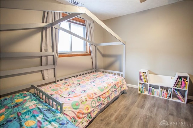 bedroom with hardwood / wood-style flooring