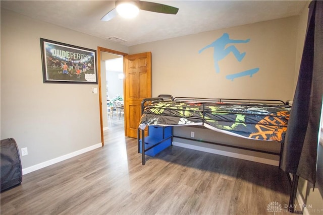 bedroom featuring hardwood / wood-style floors and ceiling fan