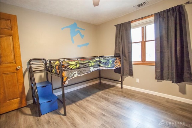 bedroom with wood-type flooring and ceiling fan