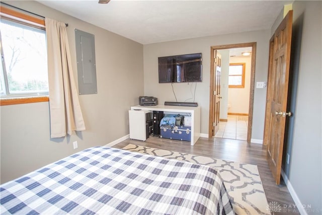 bedroom featuring wood-type flooring and electric panel