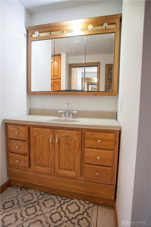 bathroom with tile patterned floors and vanity