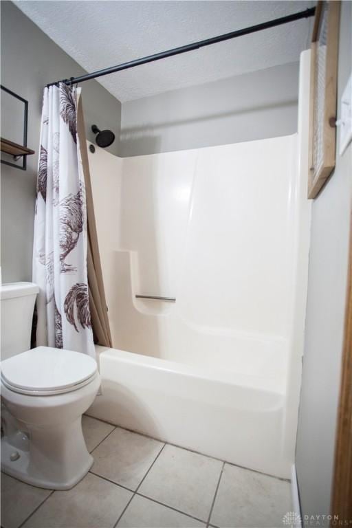 bathroom featuring tile patterned floors, toilet, and shower / bath combo with shower curtain