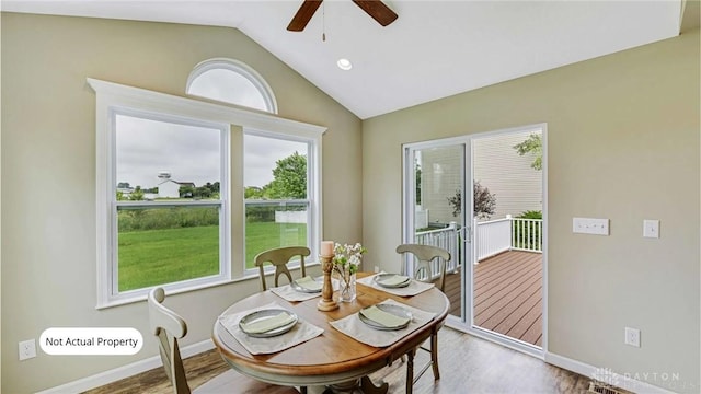 dining room featuring ceiling fan, hardwood / wood-style floors, and lofted ceiling