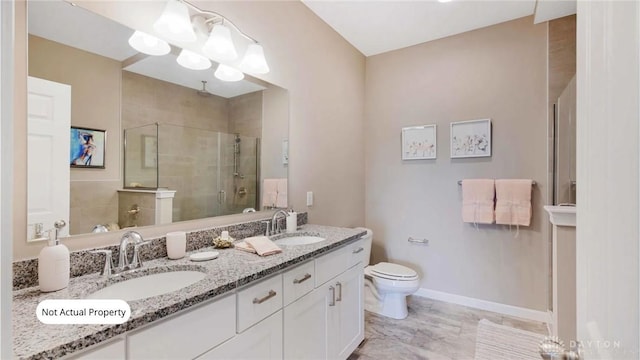 bathroom with vanity, a shower with shower door, and toilet