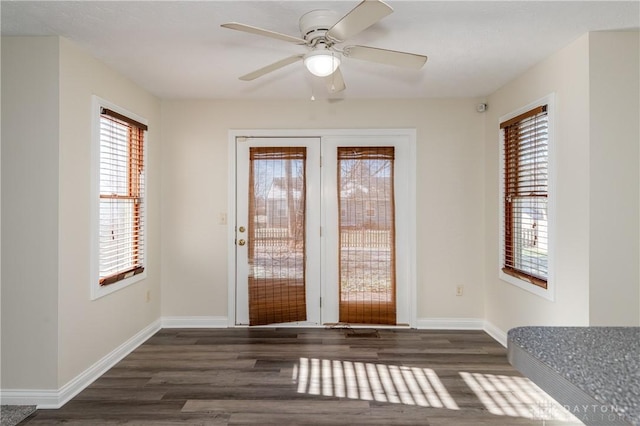 doorway to outside featuring ceiling fan and dark wood-type flooring