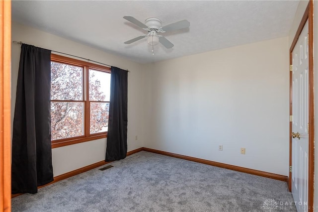 empty room with carpet floors and ceiling fan