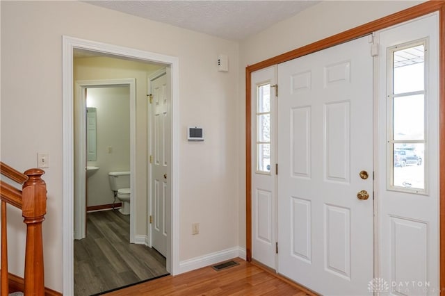 entrance foyer featuring hardwood / wood-style flooring and a textured ceiling