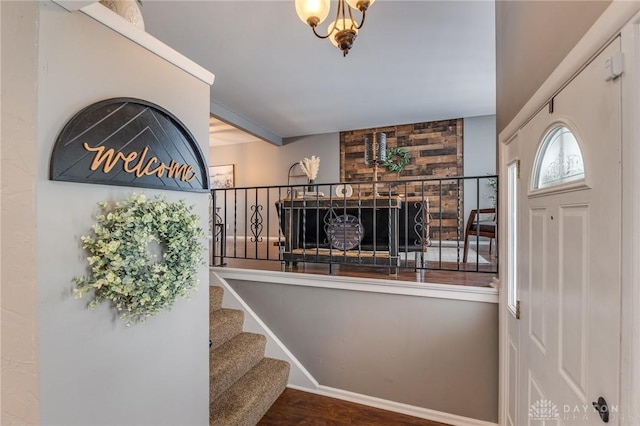 foyer entrance with a large fireplace and hardwood / wood-style flooring