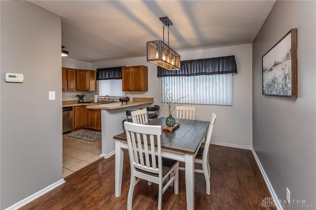 dining space with dark hardwood / wood-style floors and sink