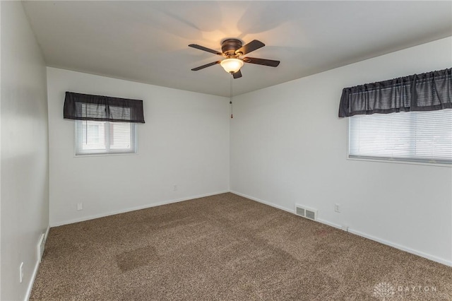 carpeted spare room featuring ceiling fan