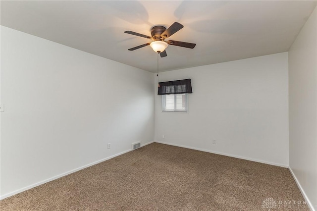 empty room featuring ceiling fan and carpet flooring