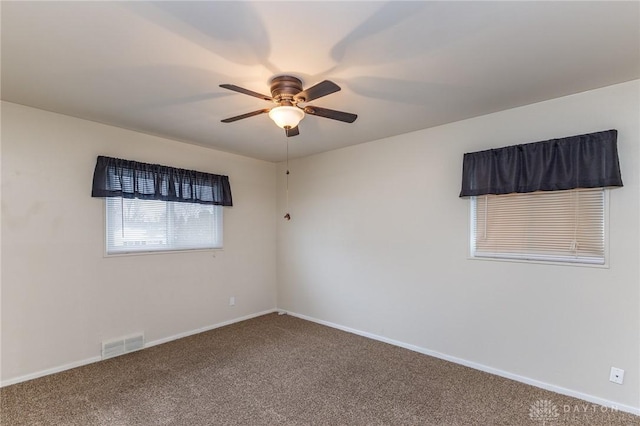 empty room with ceiling fan and carpet floors