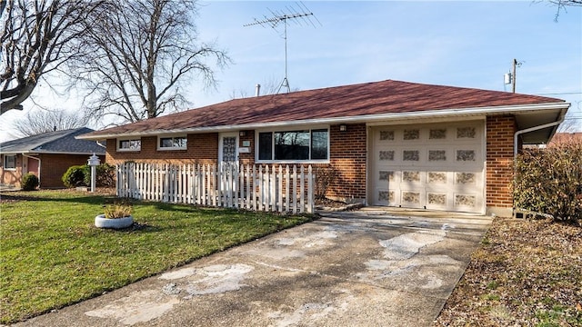 ranch-style home featuring a garage and a front lawn