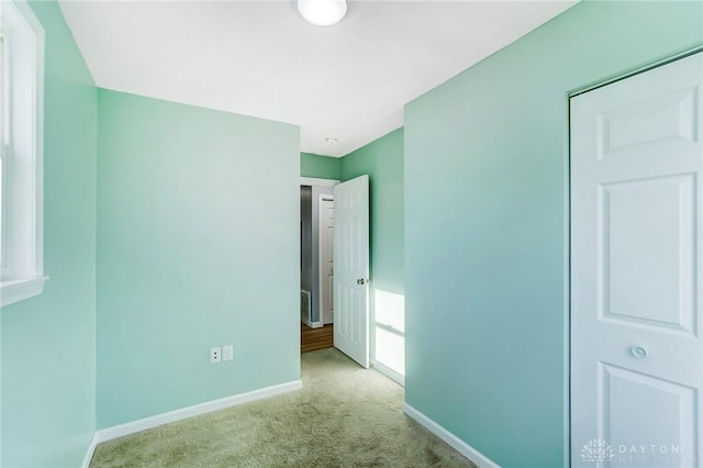 unfurnished bedroom featuring light carpet