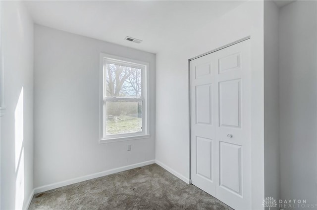 unfurnished bedroom with carpet floors and a closet