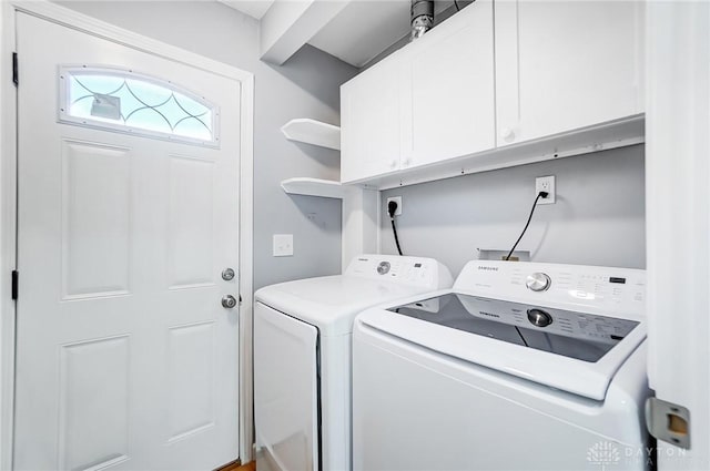 laundry area featuring cabinets and washing machine and clothes dryer