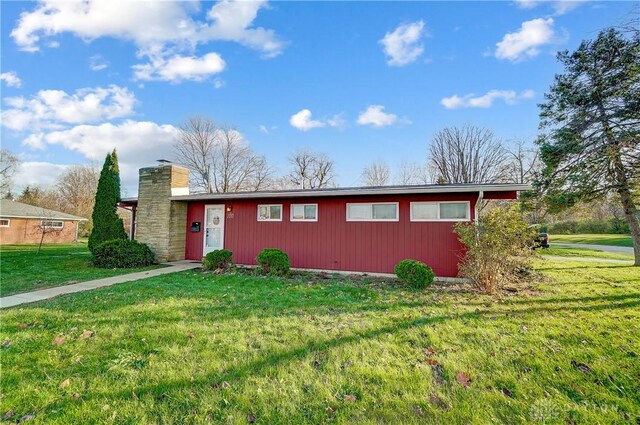 view of outbuilding featuring a lawn