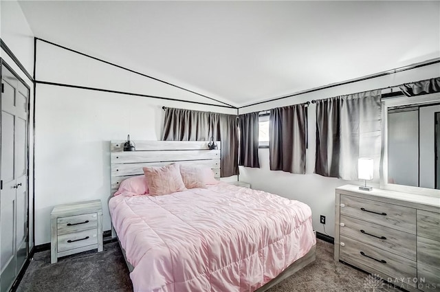 bedroom featuring baseboards, lofted ceiling, and carpet floors