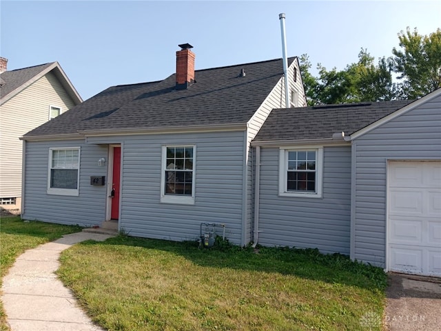 view of front facade with a front yard and a garage