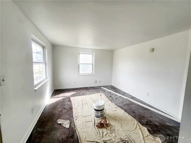 unfurnished room featuring wood finished floors and baseboards