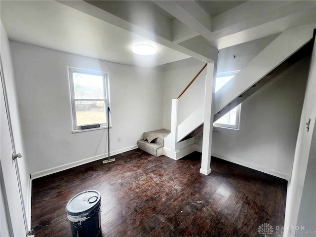 interior space featuring baseboards, stairway, a wealth of natural light, and wood finished floors