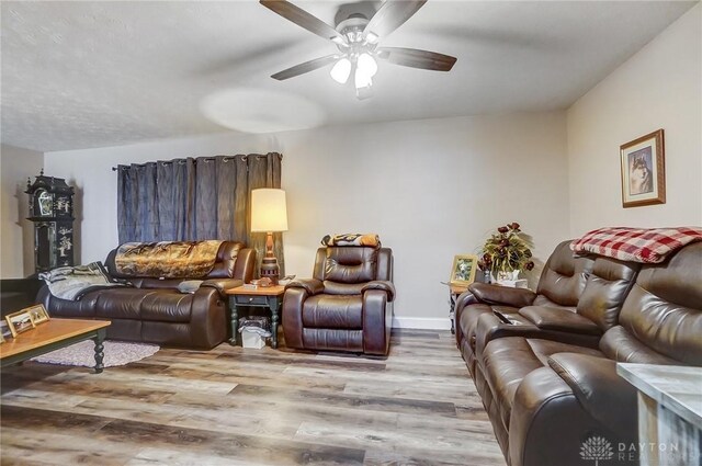 living room with ceiling fan and light wood-type flooring