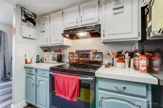 kitchen featuring electric stove, white cabinetry, wood-type flooring, and blue cabinets