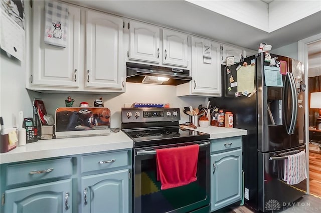 kitchen featuring white cabinets, light hardwood / wood-style floors, black fridge, and stainless steel electric stove