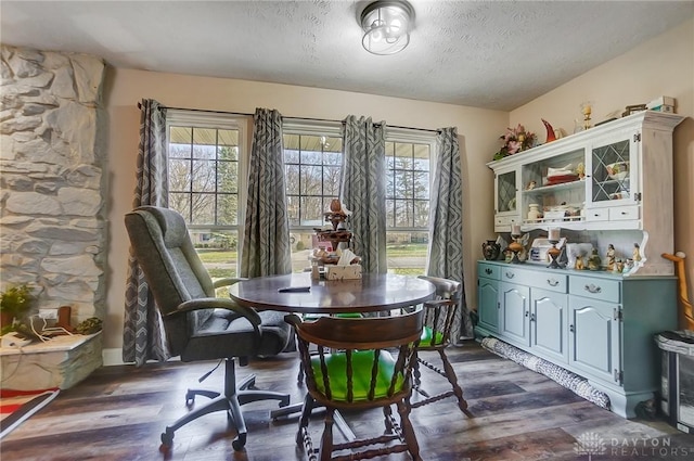 dining room featuring dark hardwood / wood-style floors and a textured ceiling