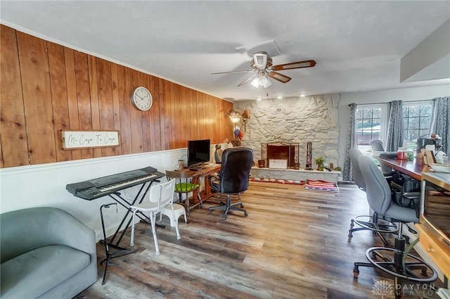 office space featuring hardwood / wood-style floors, ceiling fan, and wooden walls