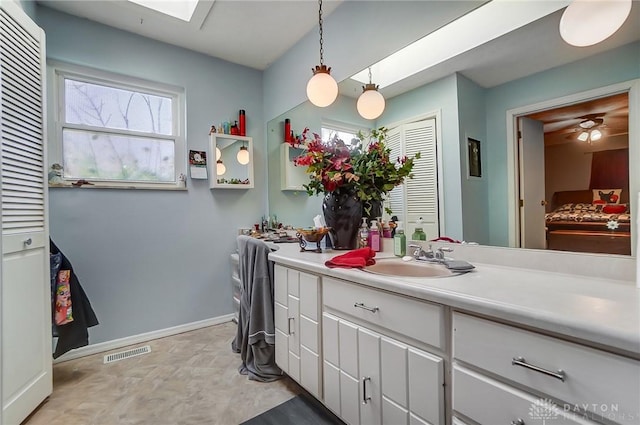 bathroom featuring vanity and a skylight