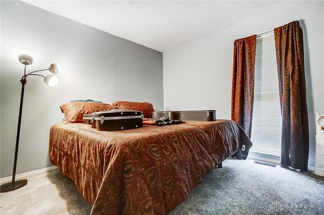 bedroom with multiple windows, light colored carpet, and lofted ceiling