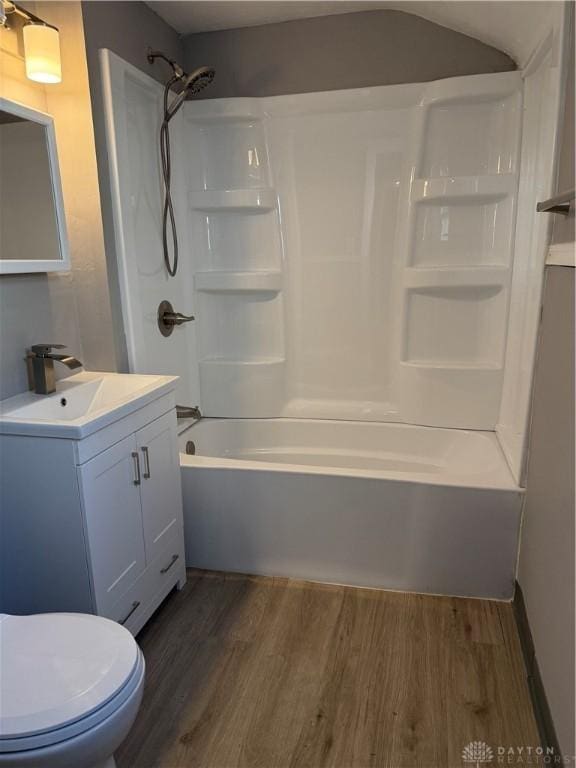 full bathroom featuring shower / bath combination, vanity, wood-type flooring, and toilet